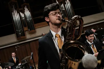 A saxophone player solos during a Jazz Orchestra Concert in Bates Recital Hall